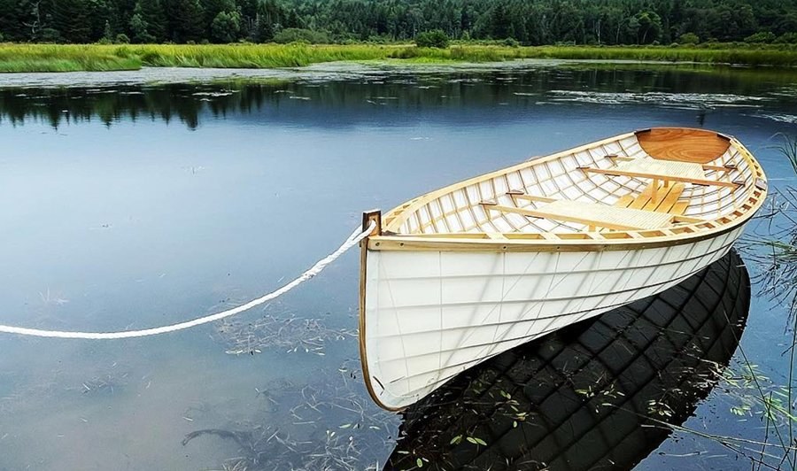 Skin-on-frame boat, finished, on the water